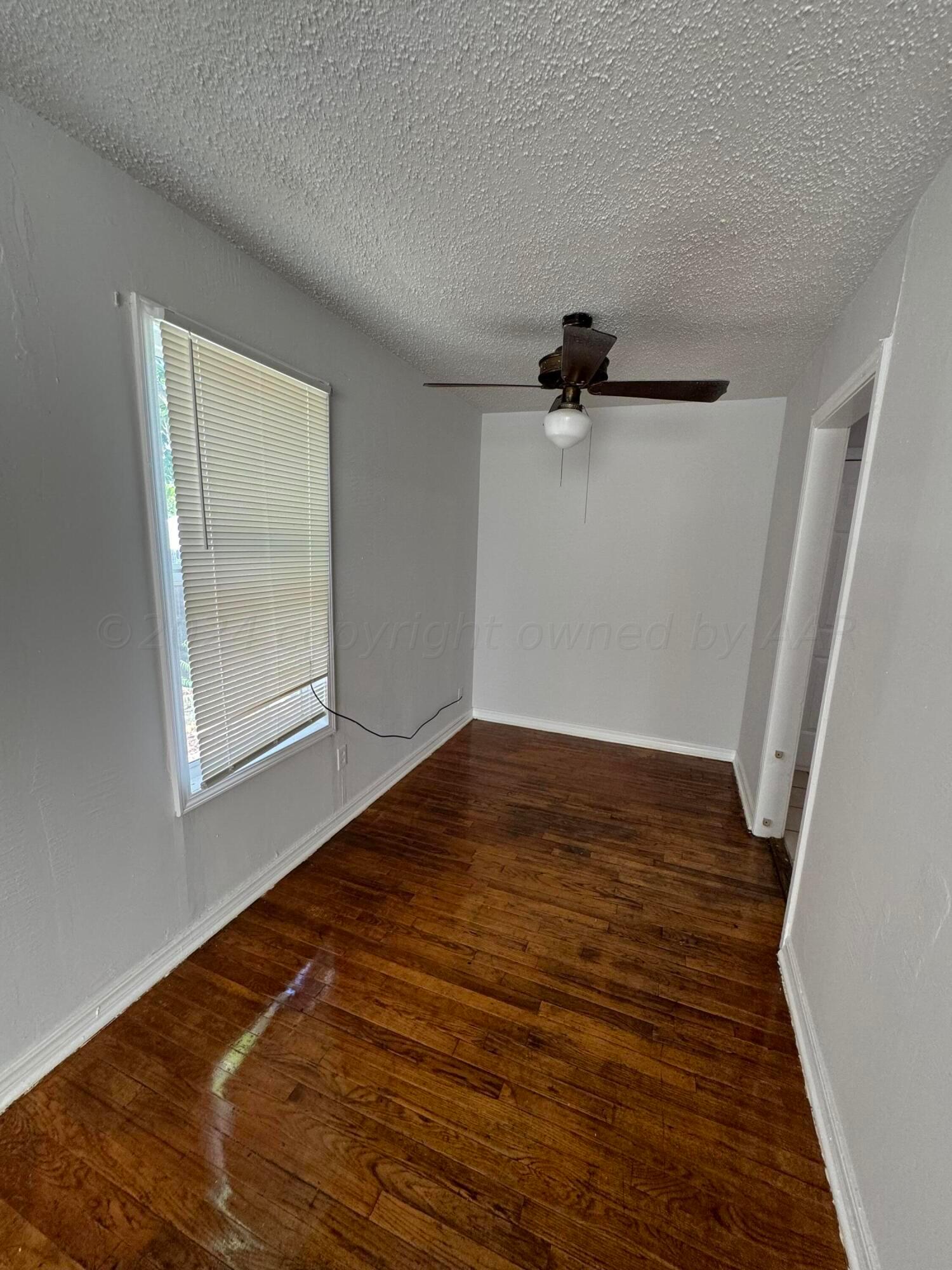 4119 Parker Street Amarillo, TX 79110 - Photo 5 of 9 a view of empty room with wooden floor