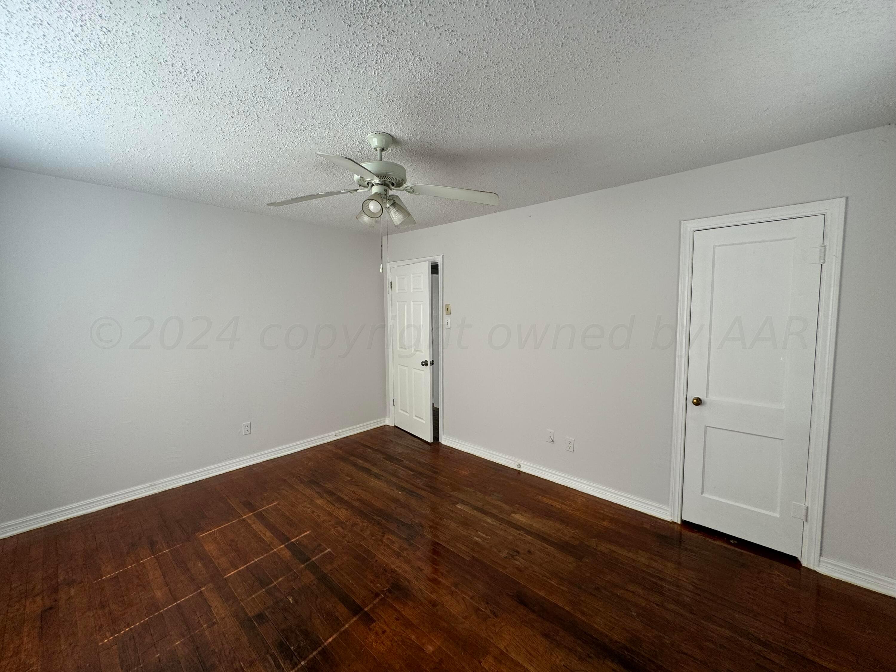 4119 Parker Street Amarillo, TX 79110 - Photo 7 of 9 a view of an empty room with wooden floor
