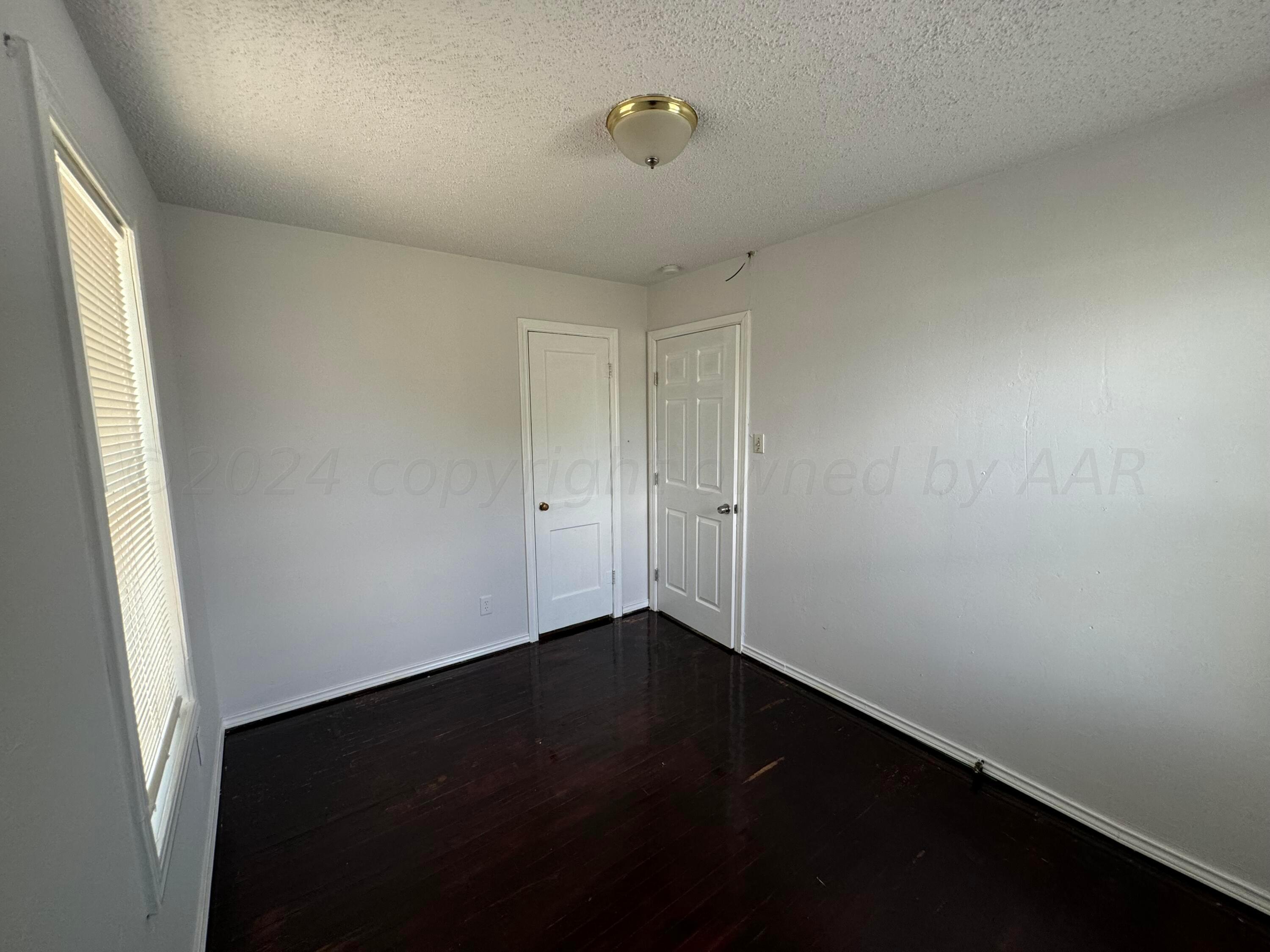 4119 Parker Street Amarillo, TX 79110 - Photo 8 of 9 an empty room with a window