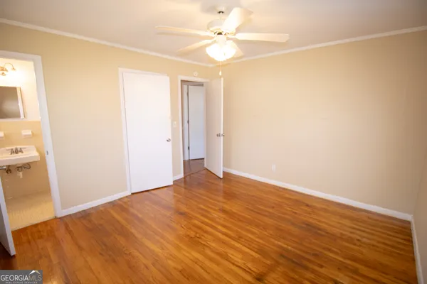 a view of an empty room with wooden floor