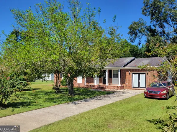 a front view of a house with a garden