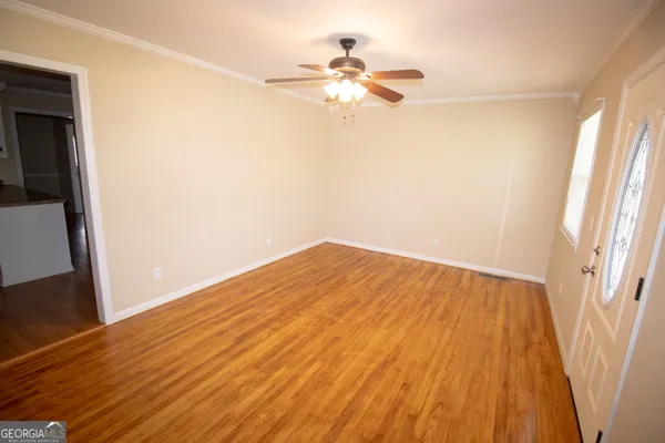 wooden floor in an empty room with a window