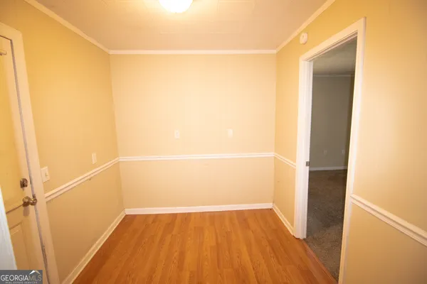 a view of a room with wooden floor
