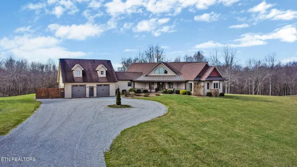a front view of a house with yard and porch