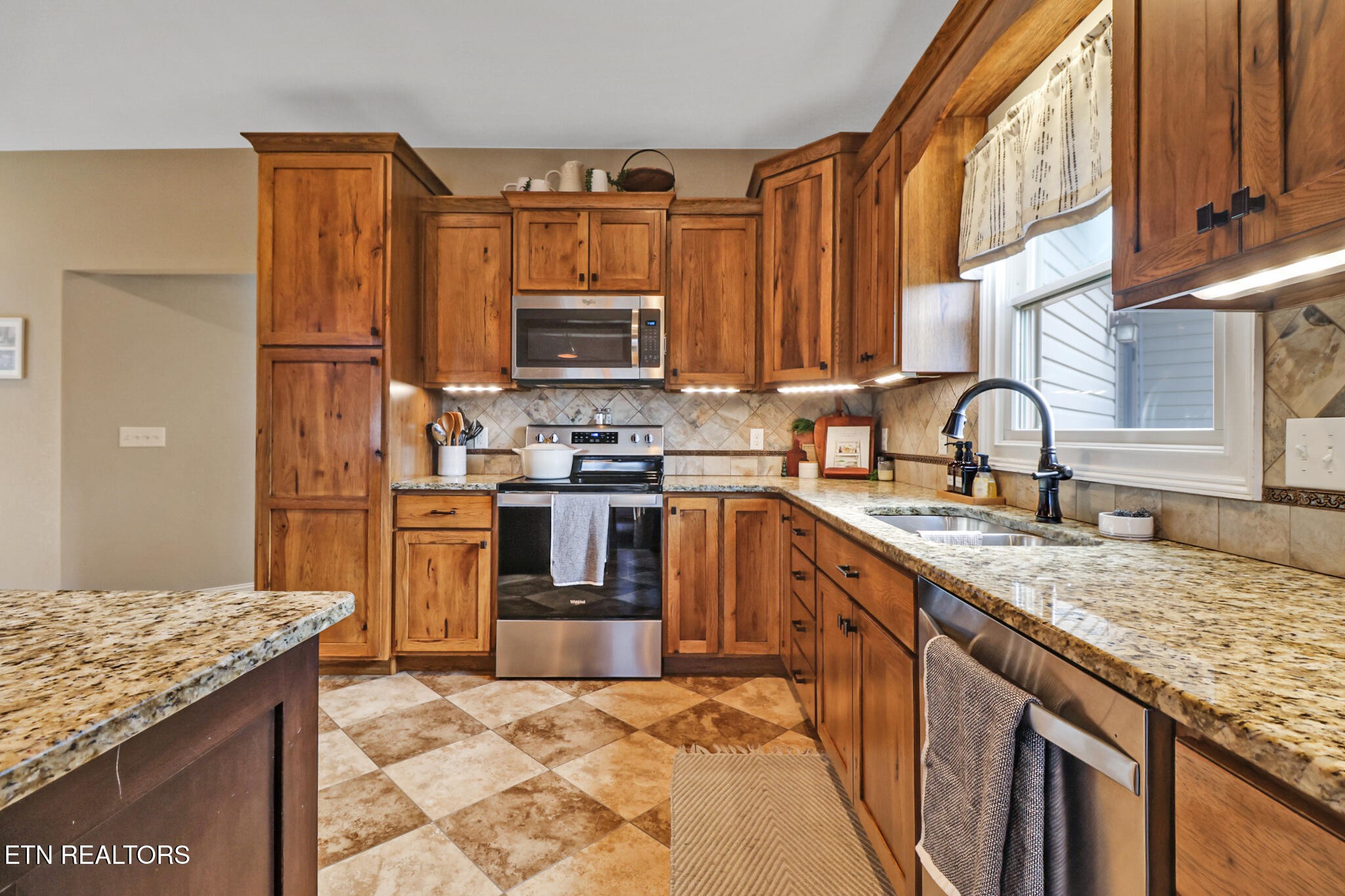 370 Randolph Road Crossville, TN 38571 - Photo 19 of 60 a kitchen with stainless steel appliances granite countertop a sink stove and refrigerator