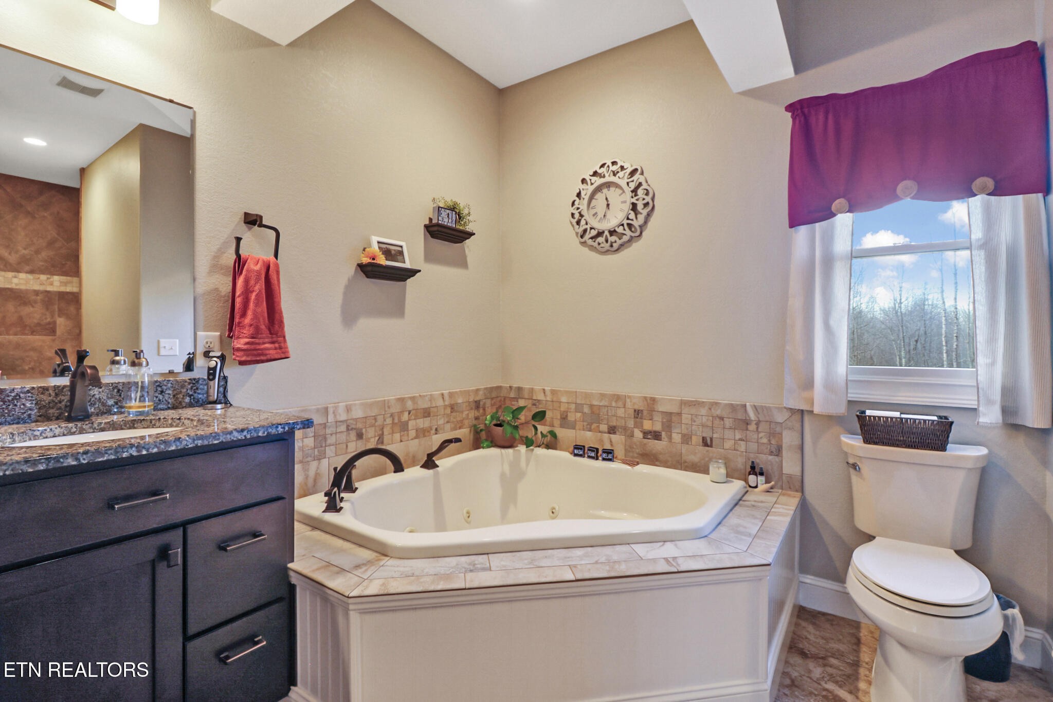 370 Randolph Road Crossville, TN 38571 - Photo 26 of 60 a bathroom with a granite countertop sink a toilet and a mirror