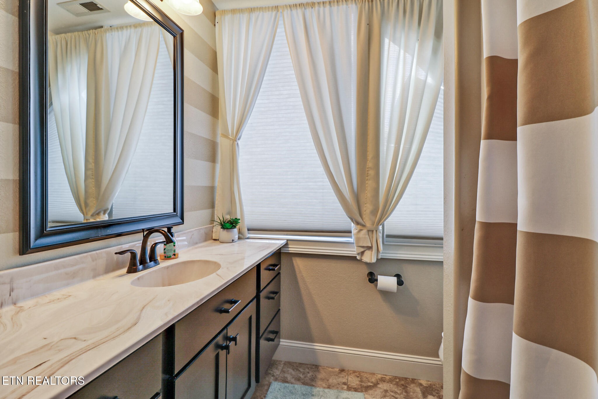 370 Randolph Road Crossville, TN 38571 - Photo 33 of 60 a bathroom with a sink a mirror and a window