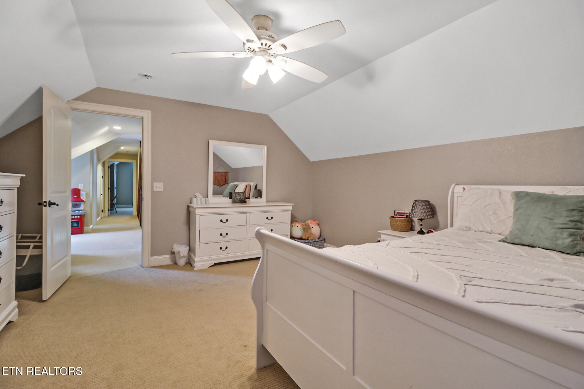 370 Randolph Road Crossville, TN 38571 - Photo 36 of 60 a bedroom with a large bed and a chandelier