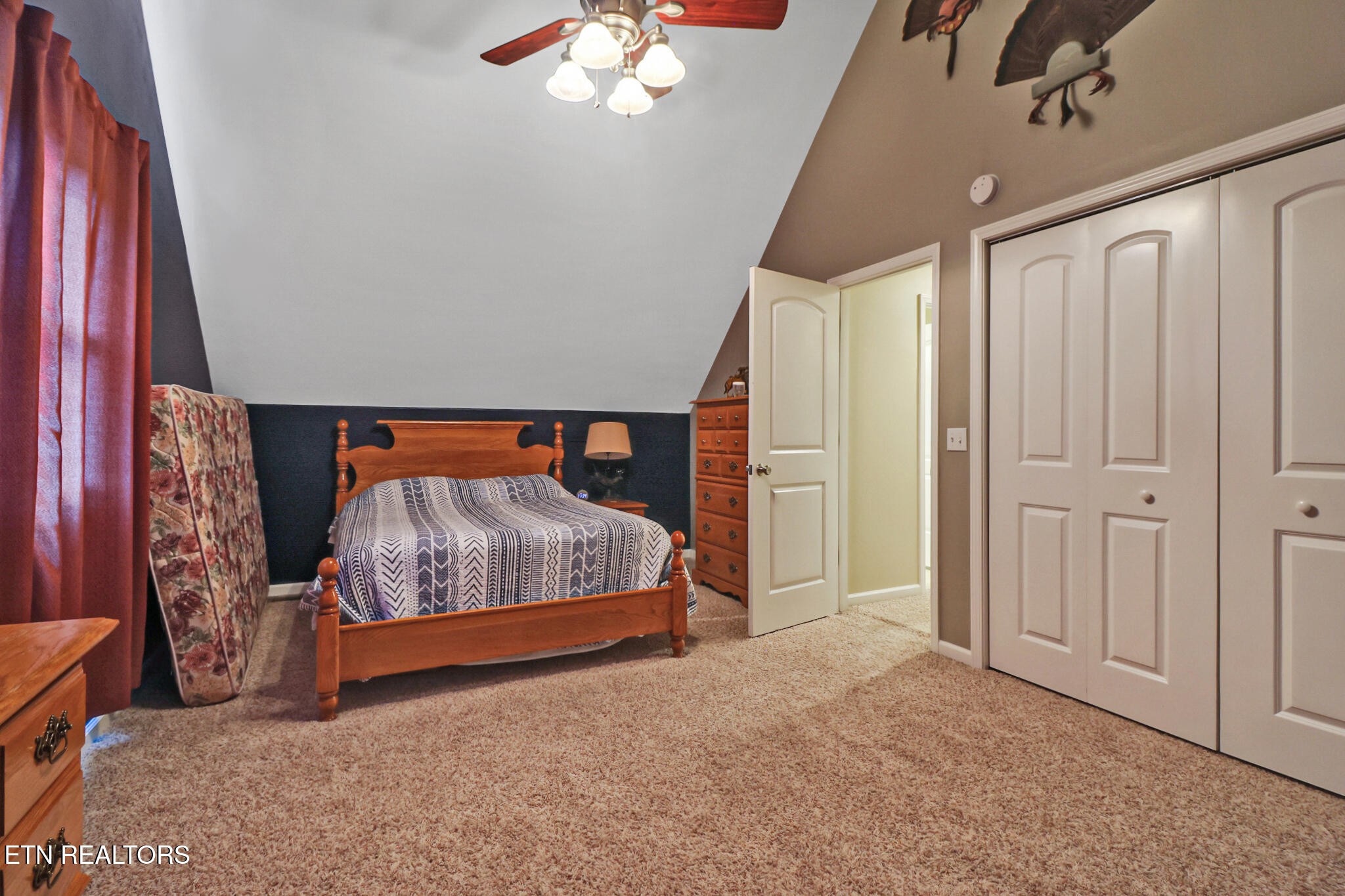 370 Randolph Road Crossville, TN 38571 - Photo 46 of 60 a bedroom with a bed and a chandelier