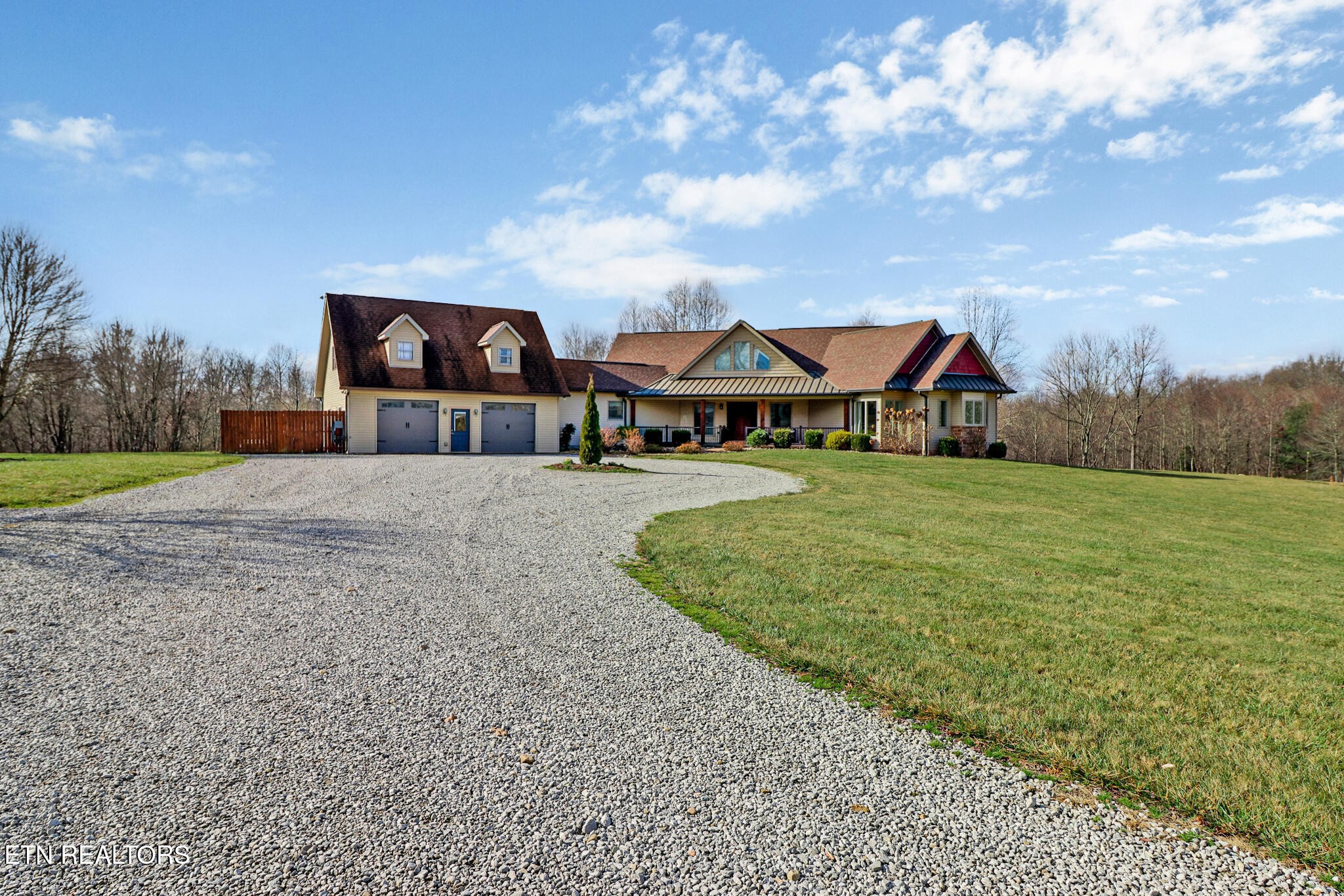 370 Randolph Road Crossville, TN 38571 - Photo 5 of 60 a view of a big house with a big yard and large trees