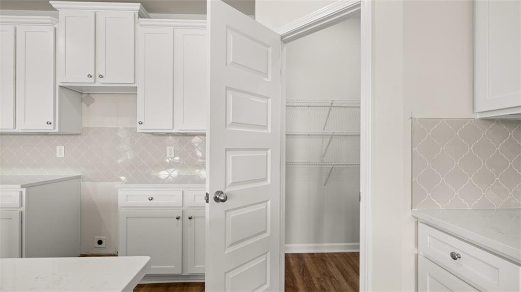 906 Stow Lane Monroe, GA 30655 - Photo 13 of 28 a view of a kitchen with white cabinets