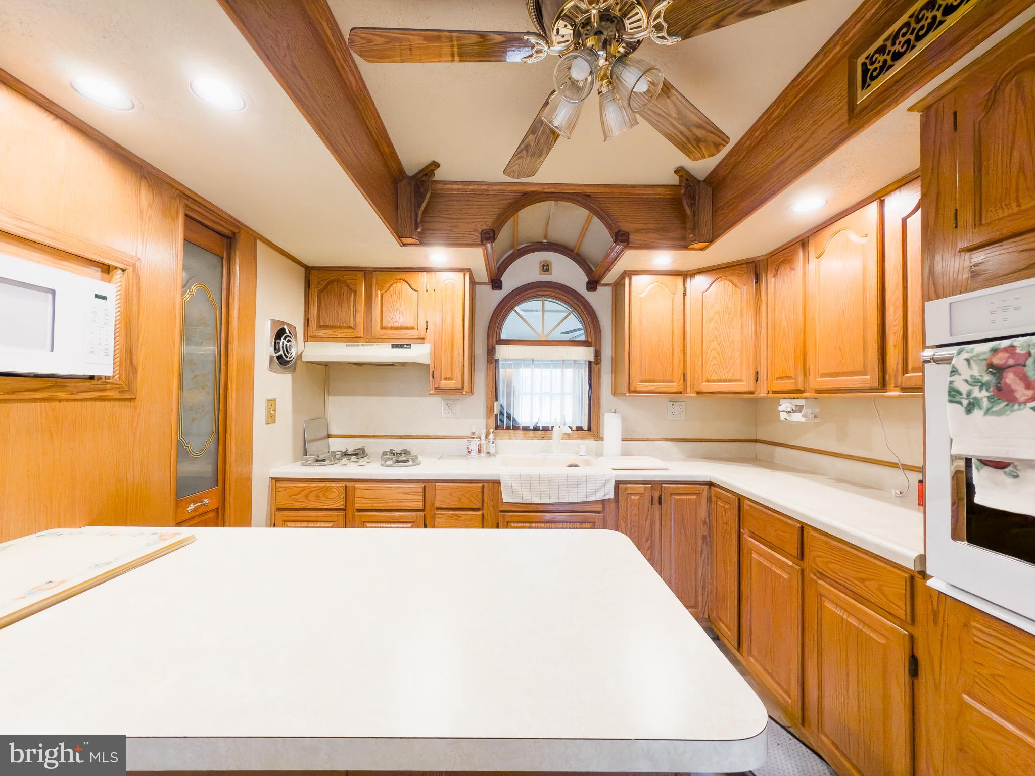 440 Durham Road Langhorne, PA 19047 - Photo 9 of 23 a view of a kitchen with kitchen island a large window a sink and stainless steel appliances