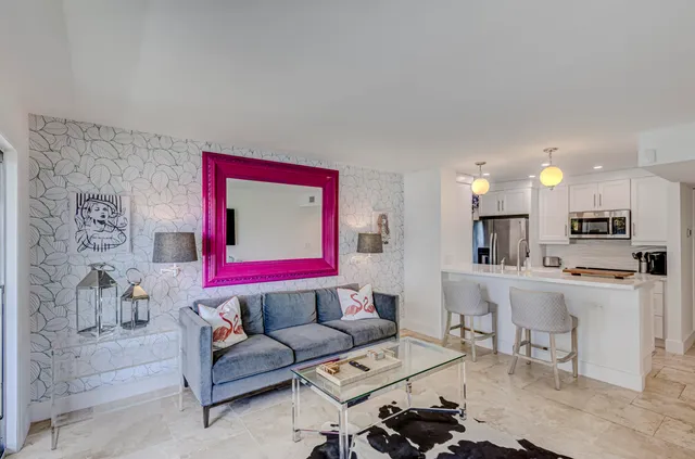 a living room with furniture and a floor to ceiling window