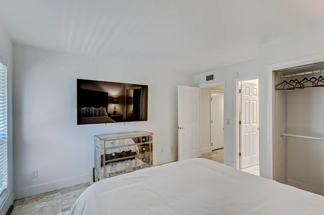 a bathroom with a toilet a sink a glass door a shower a mirror and vanity