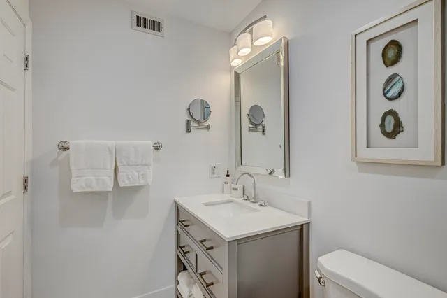 a view of a fountain in front of a house with a big yard