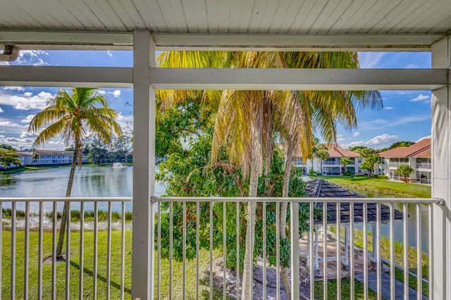 a view of a house with staircase and wooden fence
