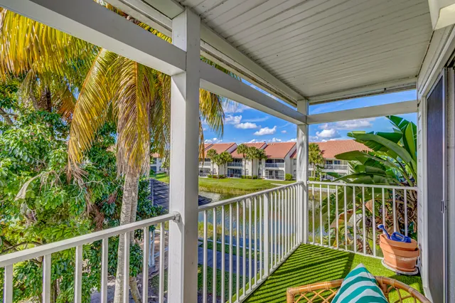 a view of a swimming pool with a garden and trees