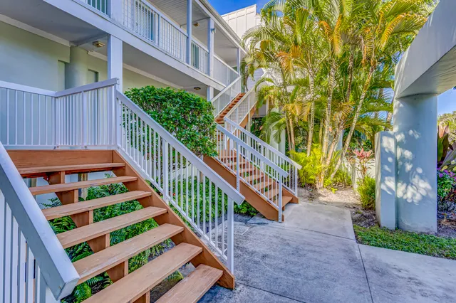 a view of a house with swimming pool and chairs