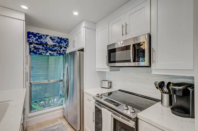 a kitchen that has a lot of cabinets a sink and a stove