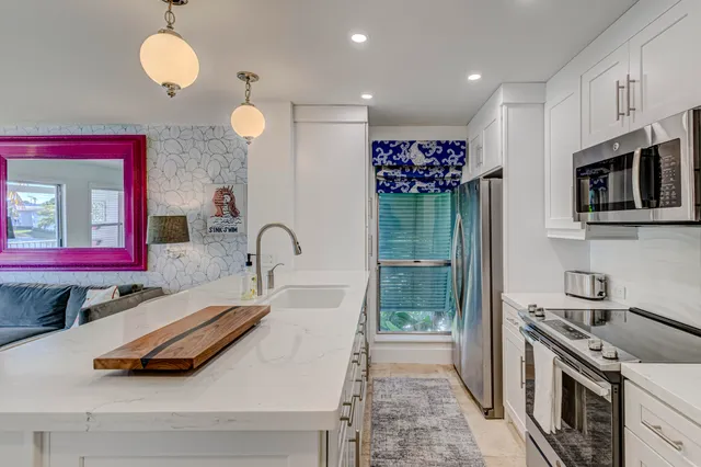 a kitchen with a refrigerator stove and cabinets