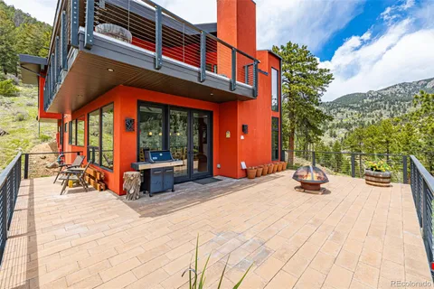a view of roof deck with chair and tables