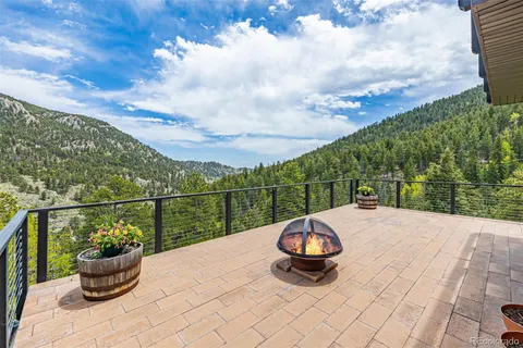 a dining room with furniture a chandelier and wooden floor
