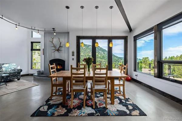 a kitchen with a large window and dining table