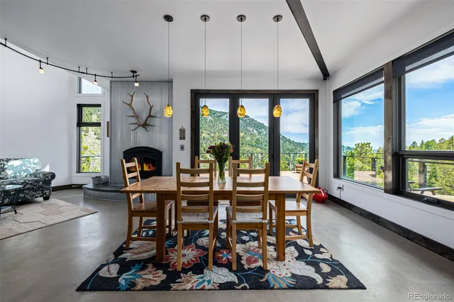 a kitchen with a large window and dining table
