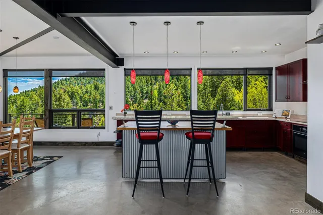 a living room filled with furniture and a large window