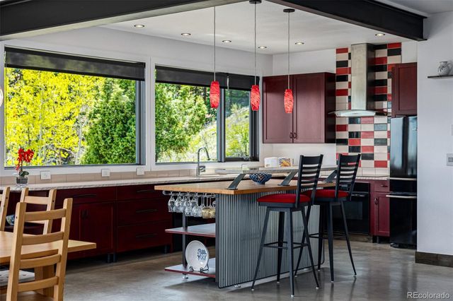 a kitchen with a sink a stove and a refrigerator