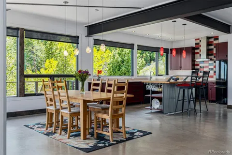 a view of a dining room with furniture window and outside view