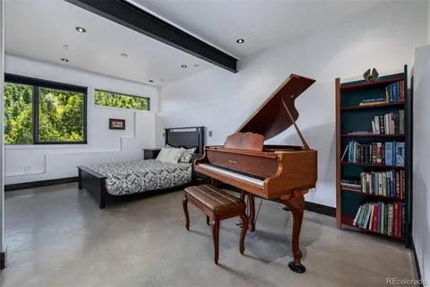 a bedroom with furniture and a closet