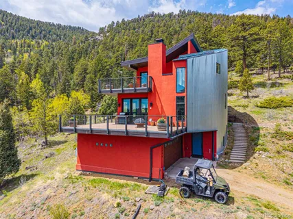 a view of roof deck with chairs and wooden fence