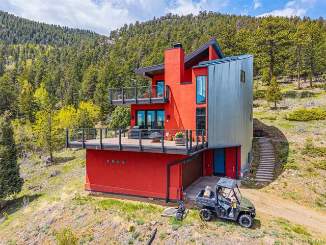a view of roof deck with chairs and wooden fence