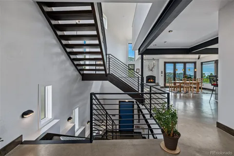 an entryway of a house with wooden floor and windows