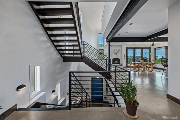 an entryway of a house with wooden floor and windows