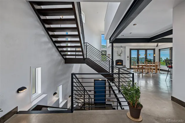 an entryway of a house with wooden floor and windows