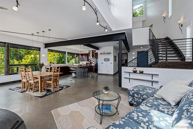 a living room with patio furniture and a large window