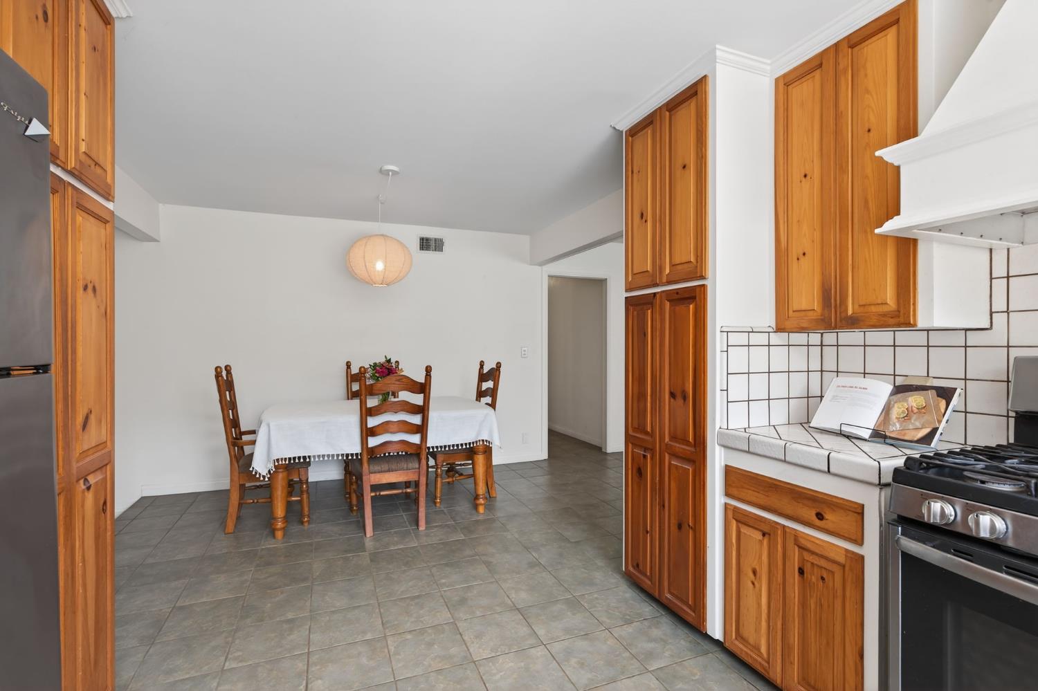 1977 South Rice Road Ojai, CA 93023 - Photo 5 of 27 a dining room with furniture a chandelier and kitchen view