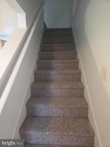 a view of a hallway with wooden floor and closet
