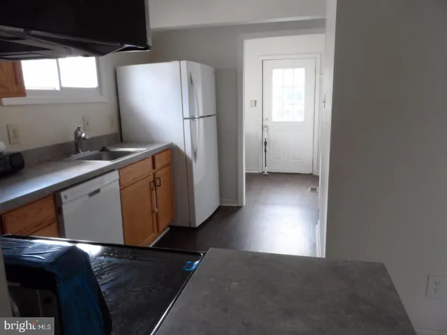 a kitchen with stainless steel appliances a refrigerator and a sink
