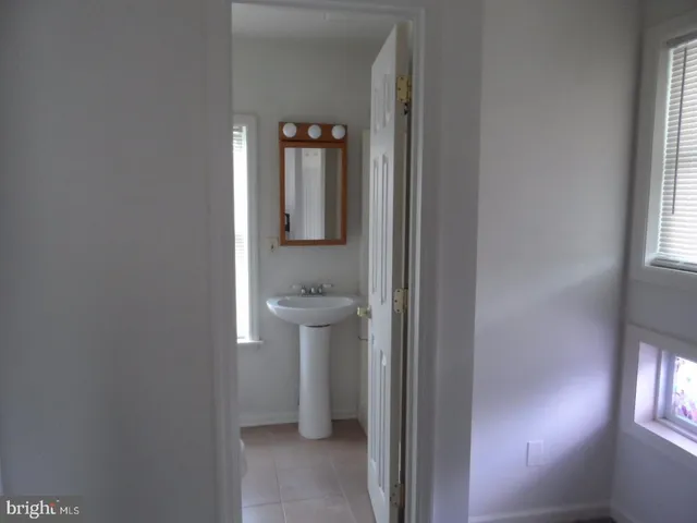 a bathroom with a sink toilet and window