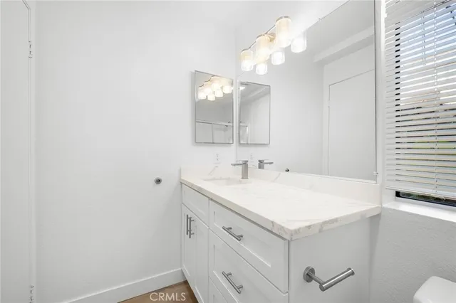 a bathroom with a sink vanity and a mirror