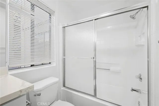 a bathroom with a shower and a toilet