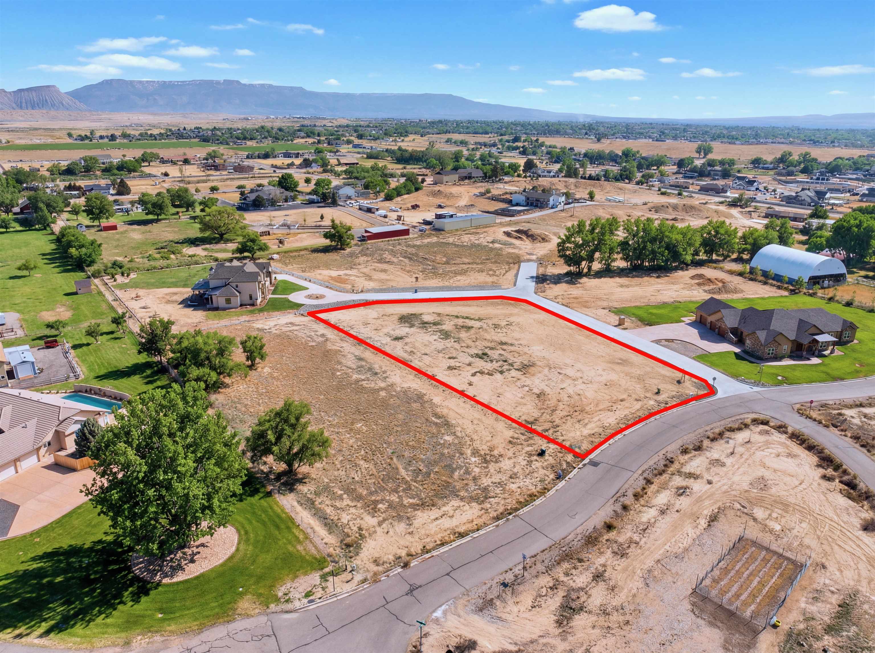 920 25 3/4 Road Grand Junction, CO 81505 - Photo 7 of 8 an aerial view of a swimming pool and mountain view in back