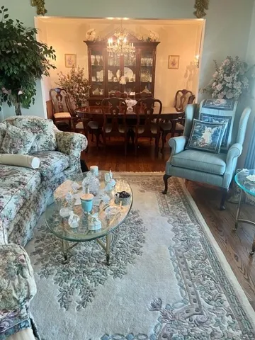 a living room with furniture and a floor to ceiling window