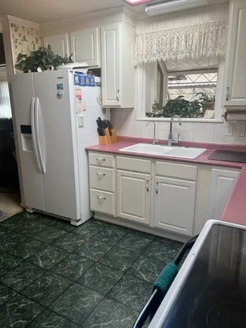a kitchen with refrigerator and window