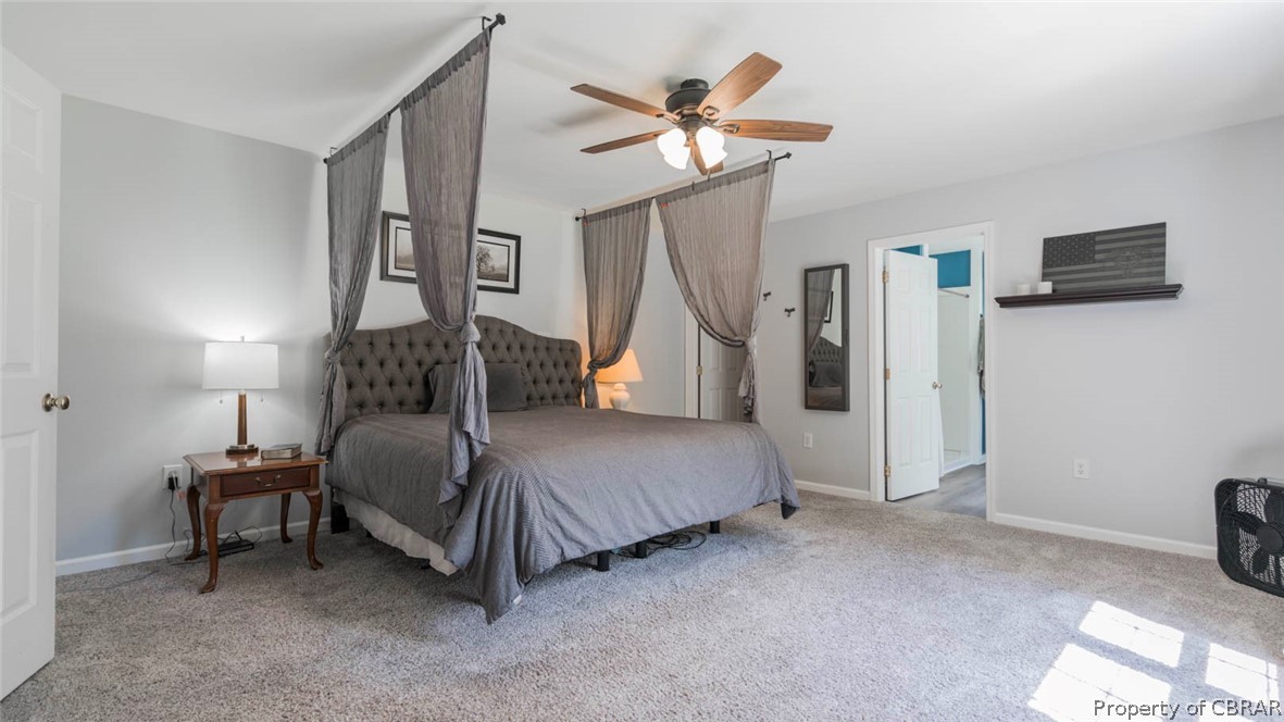 4555 Good Hope Road Lanexa, VA 23089 - Photo 20 of 49 1st floor Primary Bedroom with newer carpet and neutral decor. Extra spacious for the King size bed and all that extra furniture for a sitting area as well.