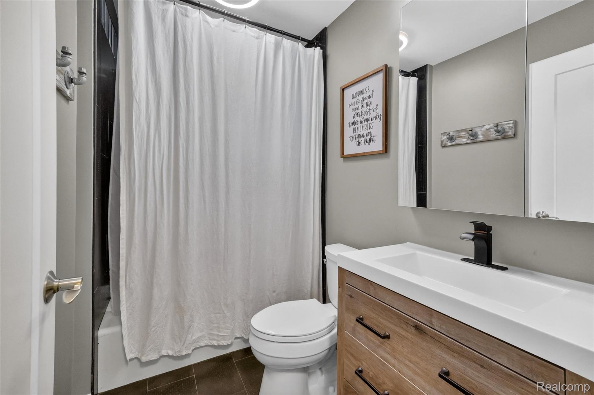 2264 Crane Road Fenton, MI 48430 - Photo 38 of 55 Full bath featuring vanity, dark tile patterned floors, and shower / tub combo