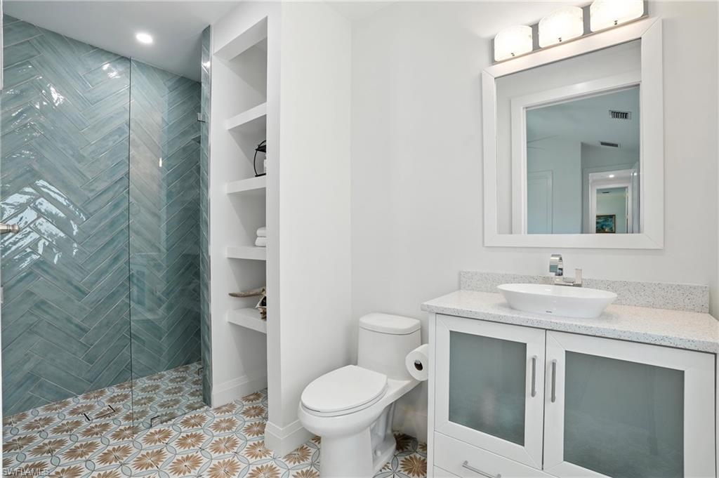 581 Wedgewood Way Naples, FL 34119 - Photo 17 of 33 a bathroom with a sink toilet and shower